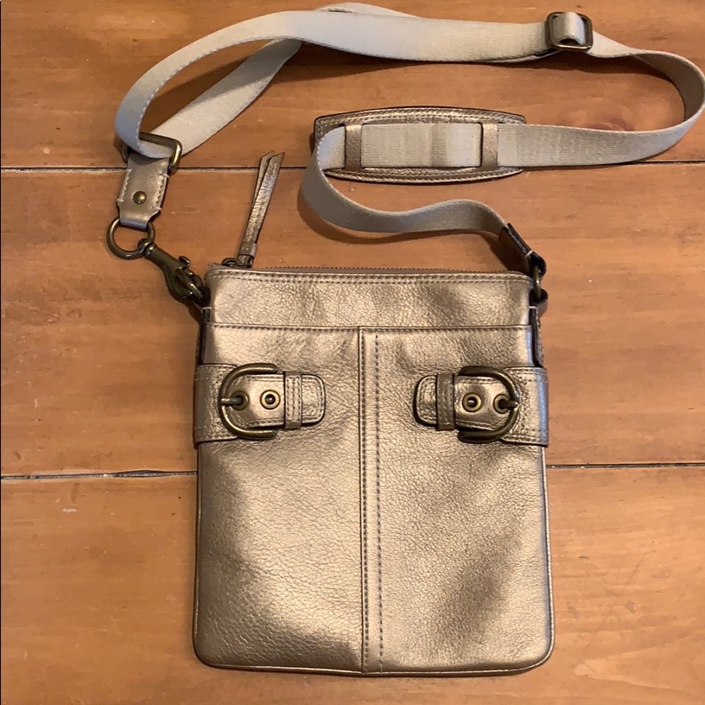 Crossbody gold metallic leather coach bag.